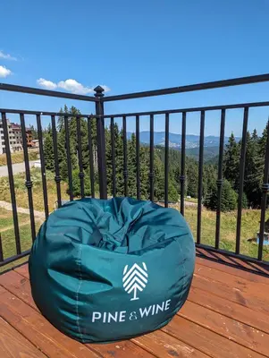a bean bag chair sitting on a deck with a view at Pine & Wine Sauna Apartment in Pamporovo