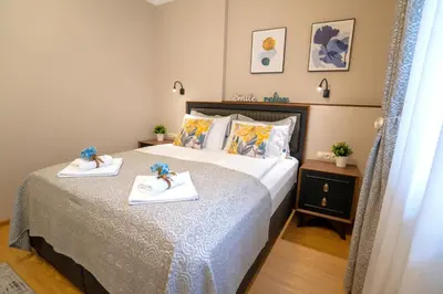 a bedroom with a bed with two towels on it at SP Urban Apartment in Plovdiv