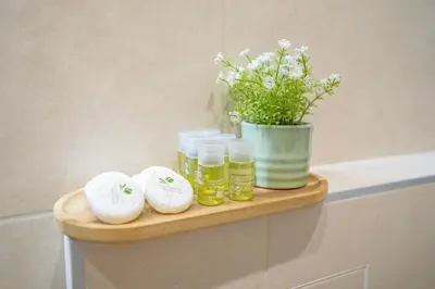 a shelf with three jars and a vase with flowers at SP Urban Apartment in Plovdiv