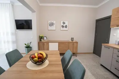 a kitchen with a table with a bowl of fruit on it at SP Urban Apartment in Plovdiv