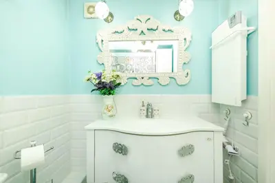 a bathroom with a white sink and a mirror at The White Apartment 3BR - free parking in Sofia