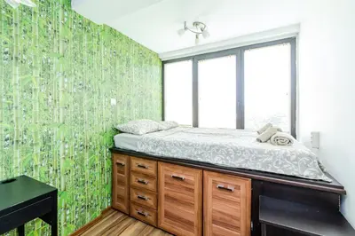 a bedroom with a bed and a green wall at The White Apartment 3BR - free parking in Sofia