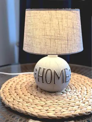 a lamp on a table with a home sign on it at Central Sofia Condo in Sofia