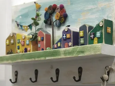a painting of buildings on top of a shelf at Central Sofia Condo in Sofia