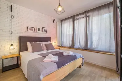 a bedroom with a large bed with two towels on it at Industrial Look Apartment Top Centre + Free Parking in Sofia