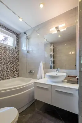 a bathroom with a sink and a tub and a toilet at Industrial Look Apartment Top Centre + Free Parking in Sofia