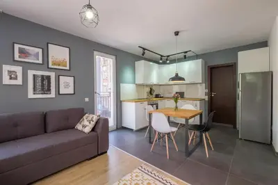 a living room with a couch and a table at Industrial Look Apartment Top Centre + Free Parking in Sofia