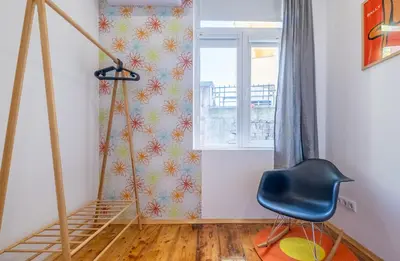 a room with a staircase and a chair and a window at Blue house Sofia Top Center 3BDR family & friends in Sofia