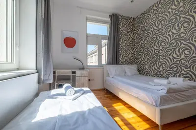 a bedroom with two beds and a wall with a pattern at Blue house Sofia Top Center 3BDR family & friends in Sofia