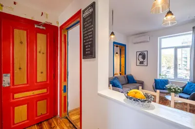 a room with a red door and a living room at Blue house Sofia Top Center 3BDR family & friends in Sofia