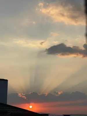 a sunset with the sun shining through the clouds at Апартамент Никола и Мария in Sapareva Banya