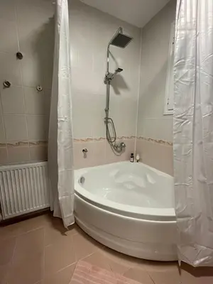 a white tub in a bathroom with a shower at Апартамент Никола и Мария in Sapareva Banya