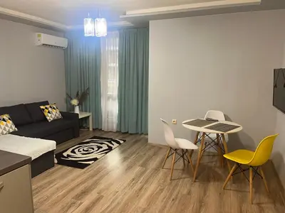 a living room with a couch and a table and chairs at Guest House Amaya Med in Plovdiv