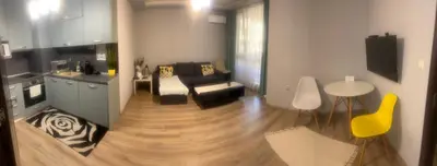 a living room with a couch and a table at Guest House Amaya Med in Plovdiv