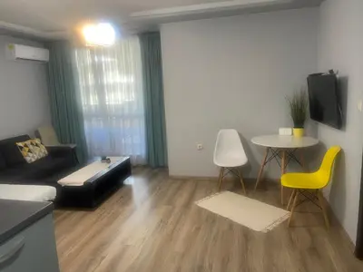 a living room with a couch and a table at Guest House Amaya Med in Plovdiv