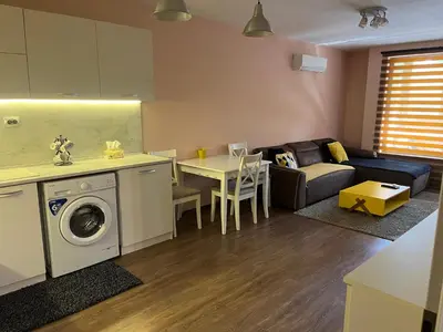 a kitchen and living room with a couch and a table at Guest House Amaya River in Plovdiv