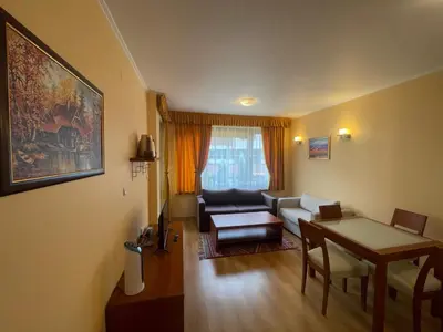 a living room with a couch and a table at Ski-in ski-out Fantastic Apartament in Bansko