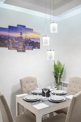 a dining room with a white table and chairs at Top Central Apartment & Free Parking in Sofia