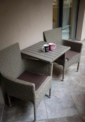 two cups of coffee sitting on a table with chairs at Top Central Apartment & Free Parking in Sofia