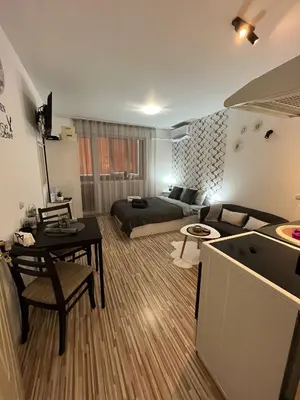 a large living room with a bed and a table at Studio John's in Blagoevgrad