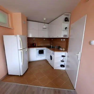a kitchen with white cabinets and a white refrigerator at 