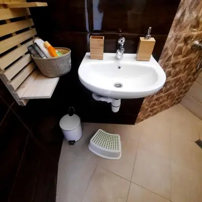 a bathroom with a white sink and a basket at 
