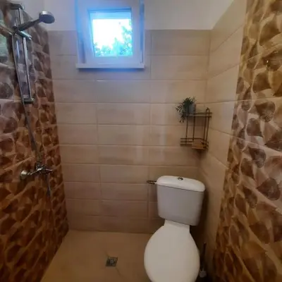 a small bathroom with a toilet and a window at 
