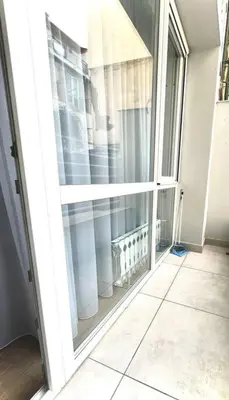 an open door to a room with a large window at Modern City Center 2 Bedroom Apartment in Sofia