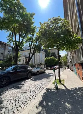 a street with cars parked on the side of the road at Modern City Center 2 Bedroom Apartment in Sofia
