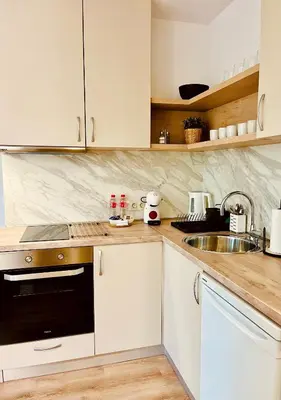 a kitchen with white cabinets and a sink at Apart-Hotels-Sofia, AHS in Sofia