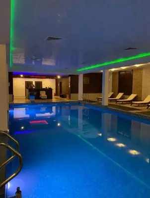 a large swimming pool with lights in a hotel at Green life, Bansko, private studio c-17 in Bansko