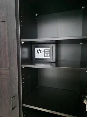 a microwave in a kitchen with black cabinets at Green life, Bansko, private studio c-17 in Bansko