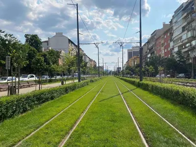 a street with train tracks in the middle of a city at Free Parkingand Relax in Sofia