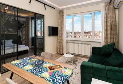 a living room with a table and a couch at Heart of the Center, 2Bedroom View Lux Apartment in Sofia