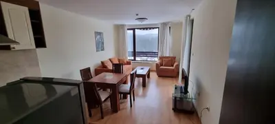 a living room with a table and chairs and a dining room at Elit Pamporovo Accommodation in Pamporovo