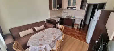 a living room with a table and a couch at Elit Pamporovo Accommodation in Pamporovo
