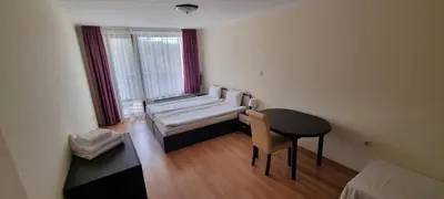 a small room with a bench and a table and a window at Elit Pamporovo Accommodation in Pamporovo