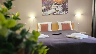 a bedroom with a purple bed with two pillows at Minkov Apartments, Пампорово - Замъка 2 in Pamporovo