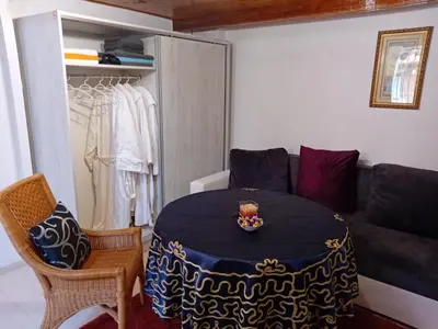 a living room with a table and a couch at Апартамент Стела in Sofia