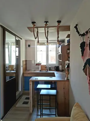a kitchen with a sink and a counter with stools at Rare view in Plovdiv