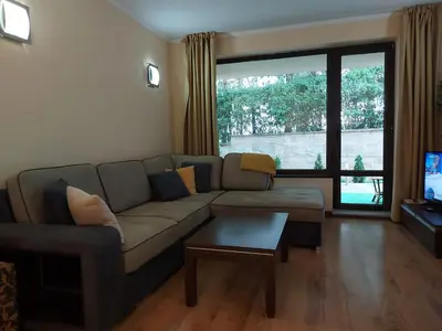 a living room with a couch and a table at Terra complex -D6 - Balkan private apartment-Spa Sking Golf and Relax in Razlog