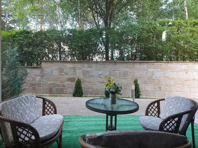 a patio with a table and chairs on a lawn at Terra complex -D6 - Balkan private apartment-Spa Sking Golf and Relax in Razlog
