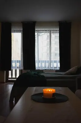 a room with two beds and a candle on a table at Sunny studio in Pamporovo in Pamporovo