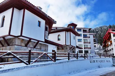 a building with a fence in front of it at Forest Nook Villas in Pamporovo