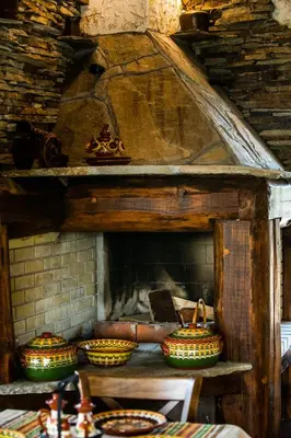 a fireplace with a group of bowls on a table at Етно комплекс 