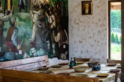 a table in a room with a painting on the wall at Етно комплекс 