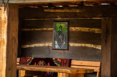 a picture on the wall of a cabin with a bench at Етно комплекс 