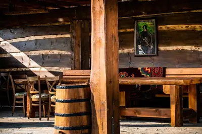 a wooden cabin with a table and chairs in it at Етно комплекс 