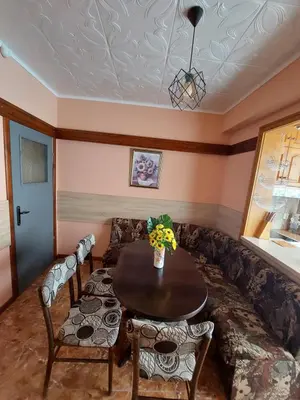 a living room with a table and a couch at Familia Apartments in Samokov