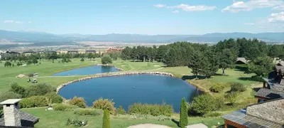 an aerial view of a golf course with a pond at ALL VIEW in Golf Resort in Razlog